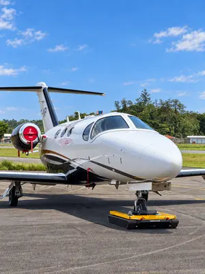 AEROTANK electric tug on the nose wheel of an Embraer Phenom business jet
