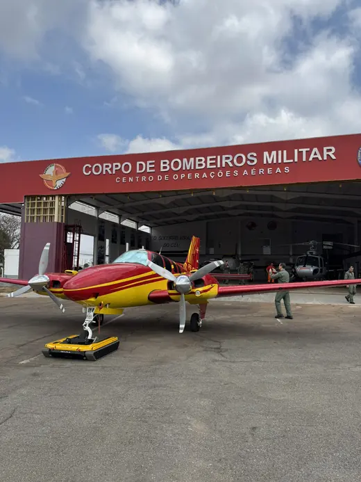 Military fire department twin-engine aircraft moved by the AEROTANK in front of the hangar